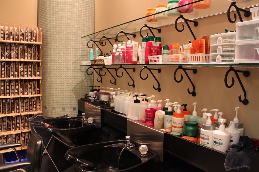 Salon wash basins and professional hair care products at the backbar