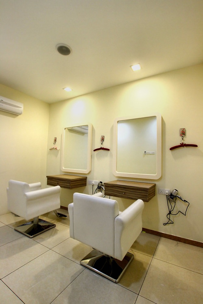 Clean white styling chairs and mirrors at the salon